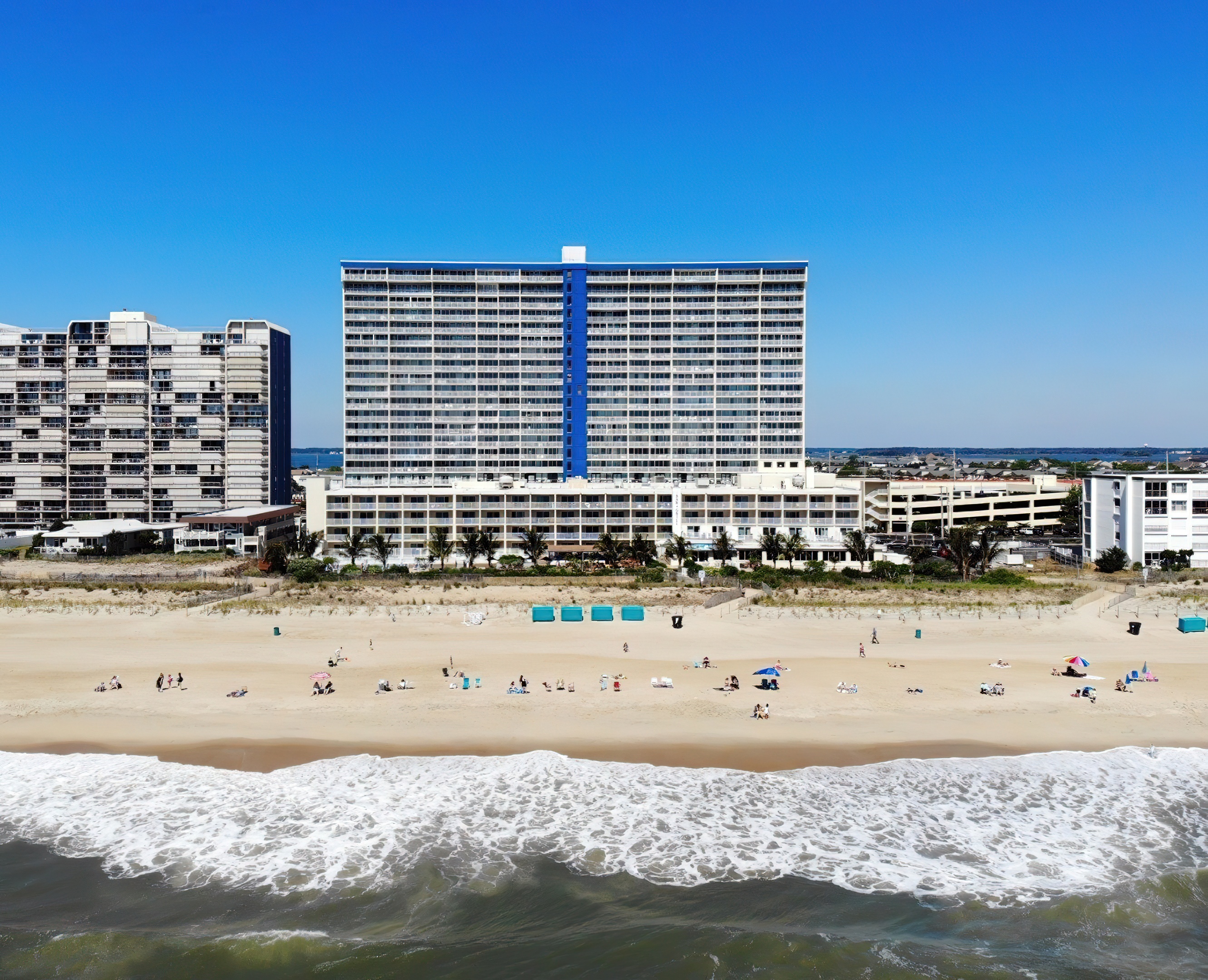 the beach is crowded with people and hotels