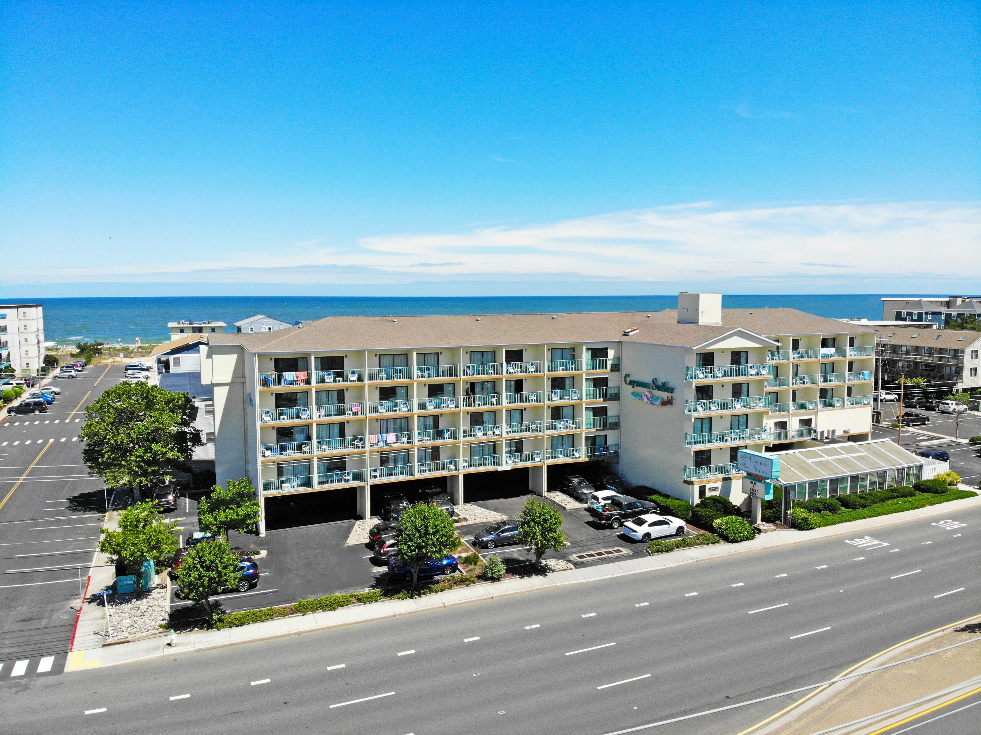 an aerial view of a hotel and parking lot - exterior of Cayman Suites